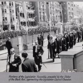 Members of the Legislative Assembly, preceded by the Usher of the Black Rod, approaching the Legislative Council Chamber - 1954